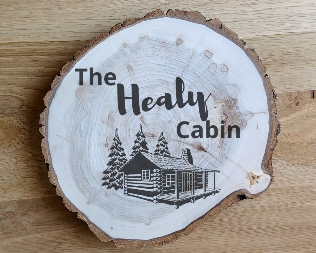 Cabin with Trees Round Sign